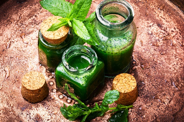 Mint essential oil in a glass bottle.Healing plants